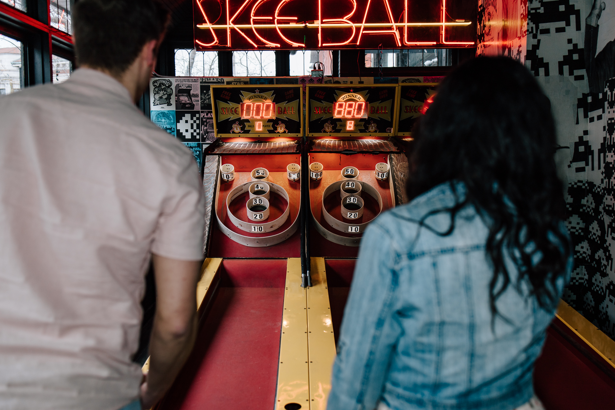 An engaged couple playing skeeball at Up-Down Arcade in St. Louis, Missouri.